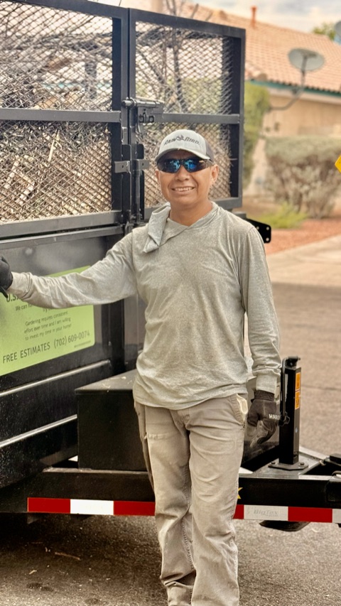 Martin Garcia beside his U.S. Lawn Care Services trailer